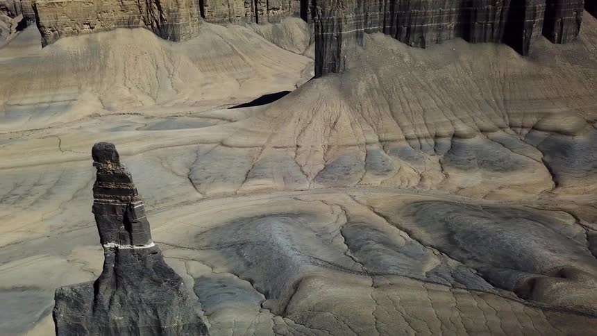 The tall rocks have a grey valley below