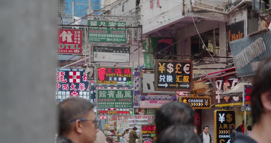 The city is covered with flashing signs as people travel around
