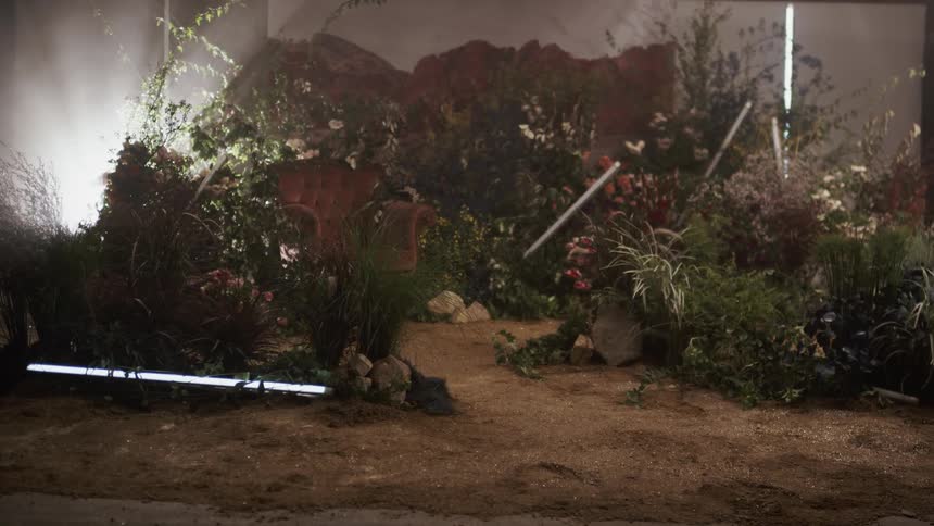 The set is decorated with lights and flowers