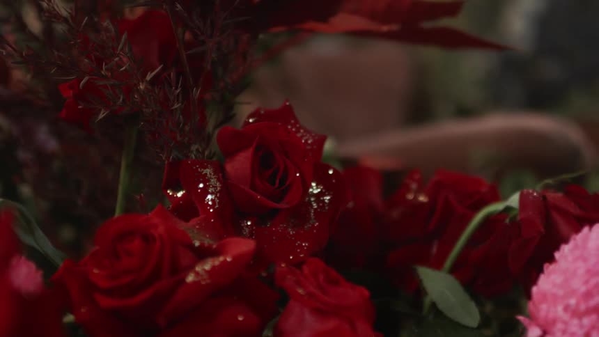 Bouquet of red flowers with silver glitter on their petals
