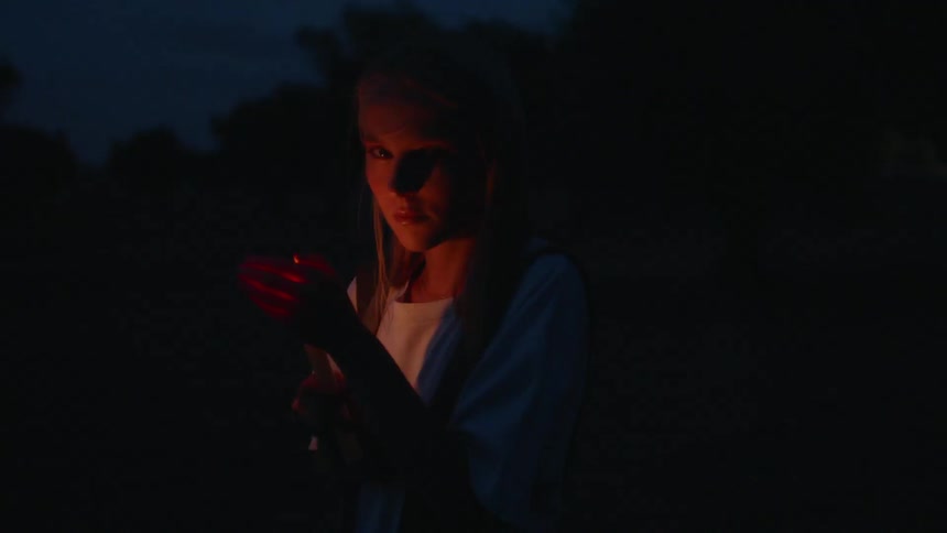 The candle flickers lighting up her face at night