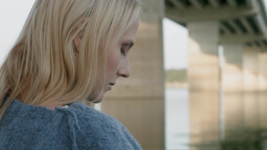 The woman is standing in the water resting