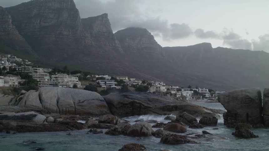 Waves crash towards the rocky shore