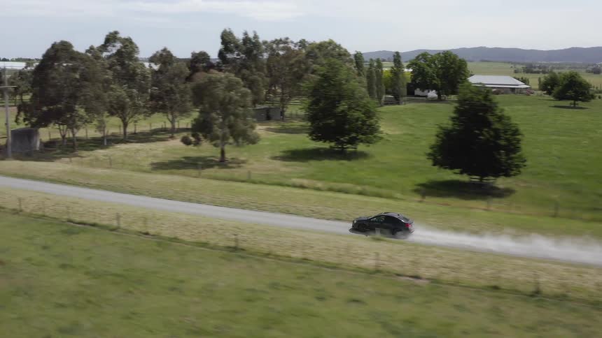 Car is traveling on sunny country road
