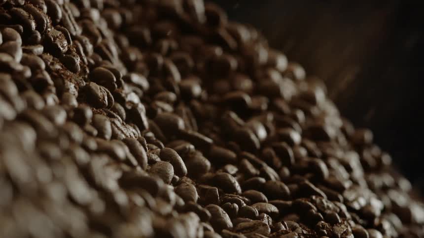 Coffee beans are falling into a pile