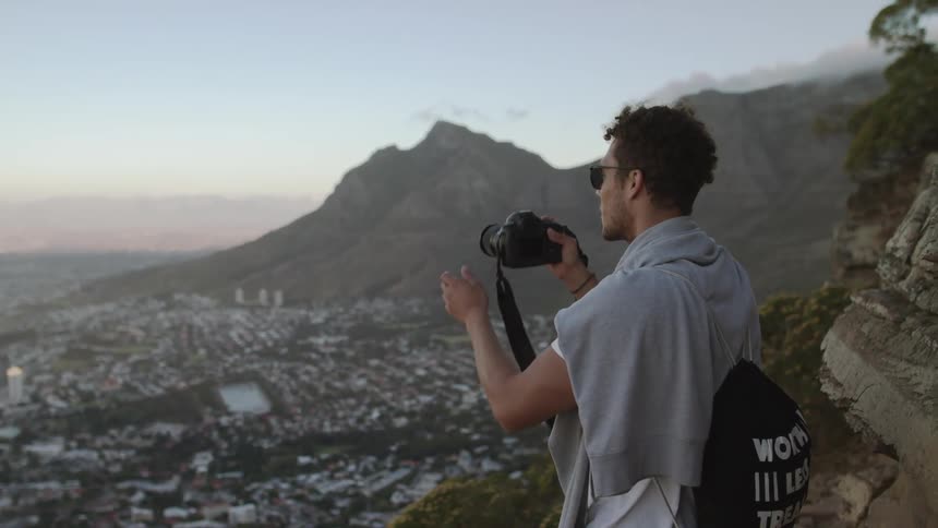 A man is photographing on the hill above the town