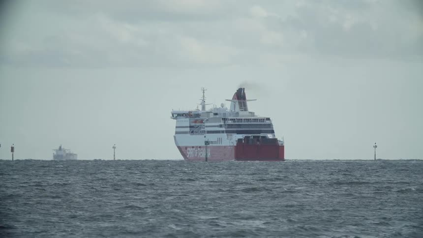 A large ship is sailing in the water ahead