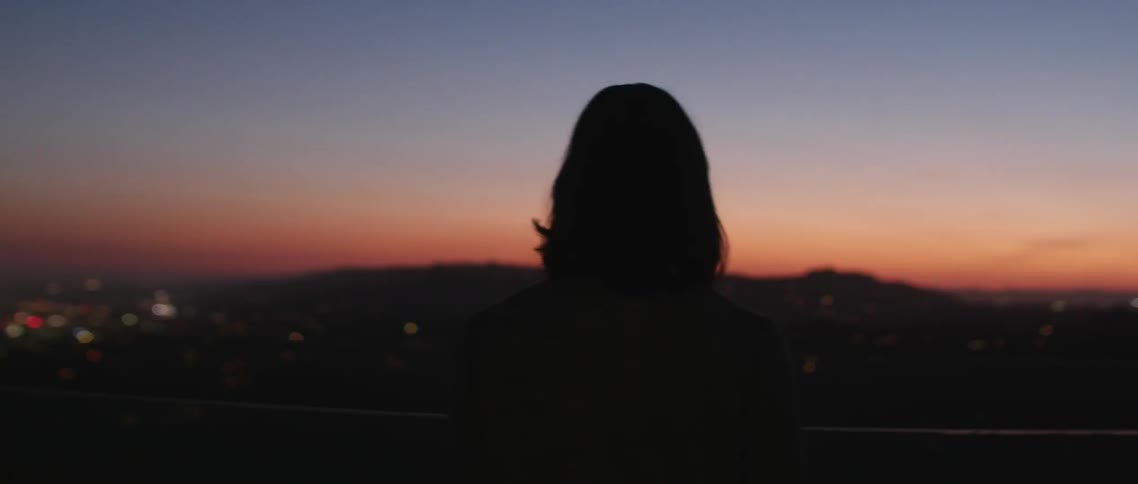 Woman walking at sunset outside