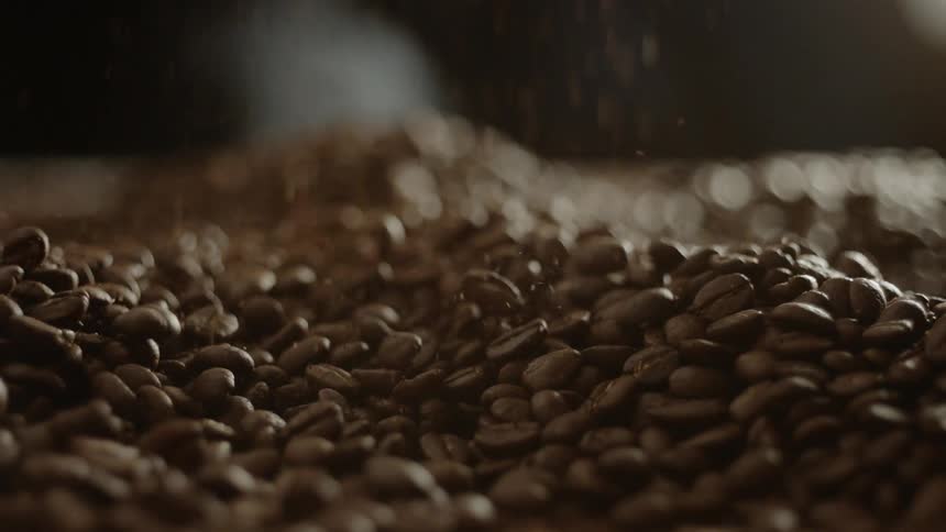 Coffee beans pour onto a pile