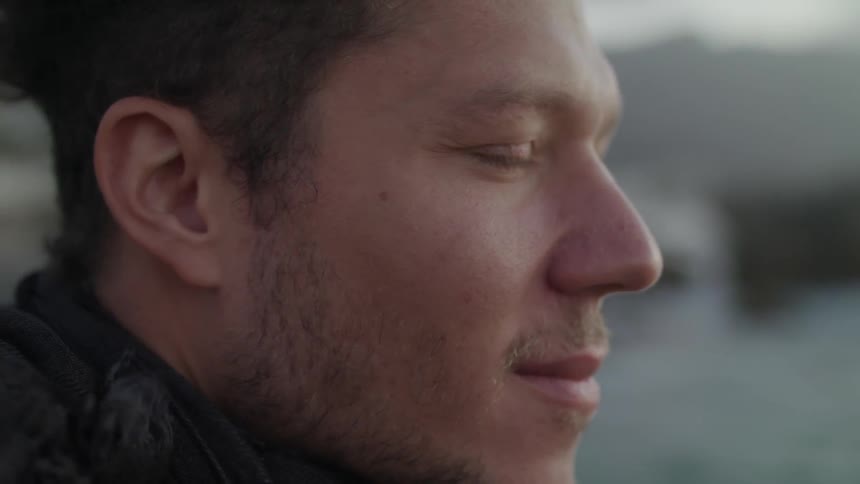 Smiling man's hair waves in the wind