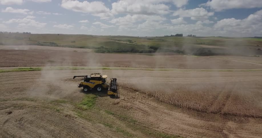 A farm tractor works the field below