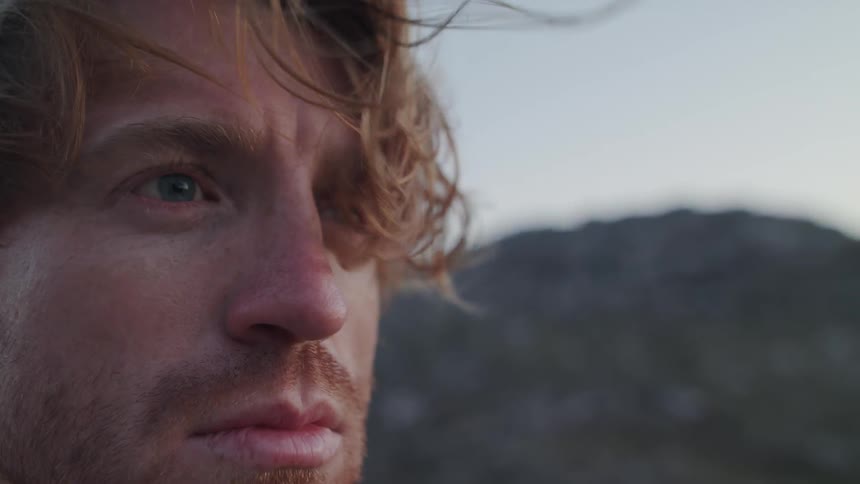 A man's hair is blown by the wind