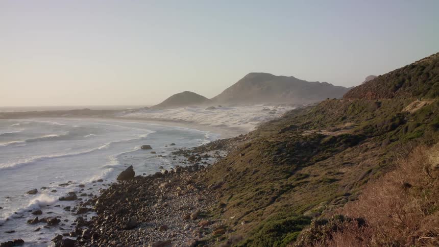 The waves crash on the shore line