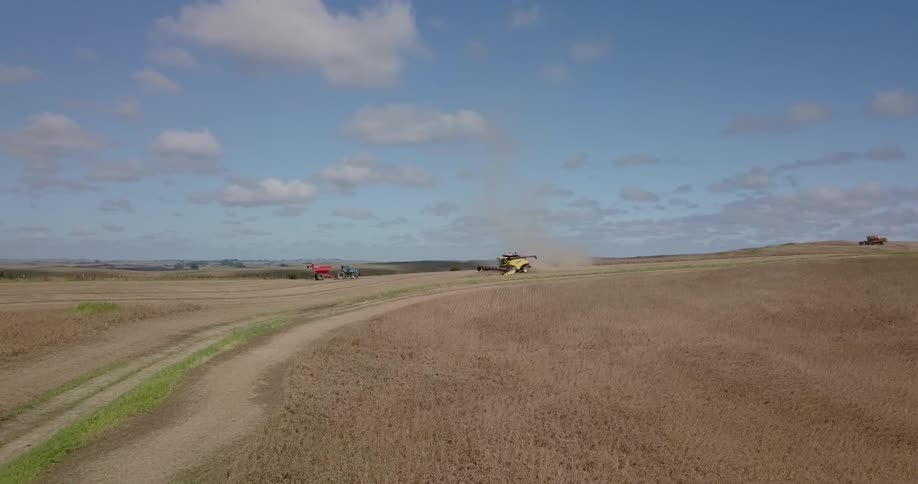 The farm vehicle is working the field ahead