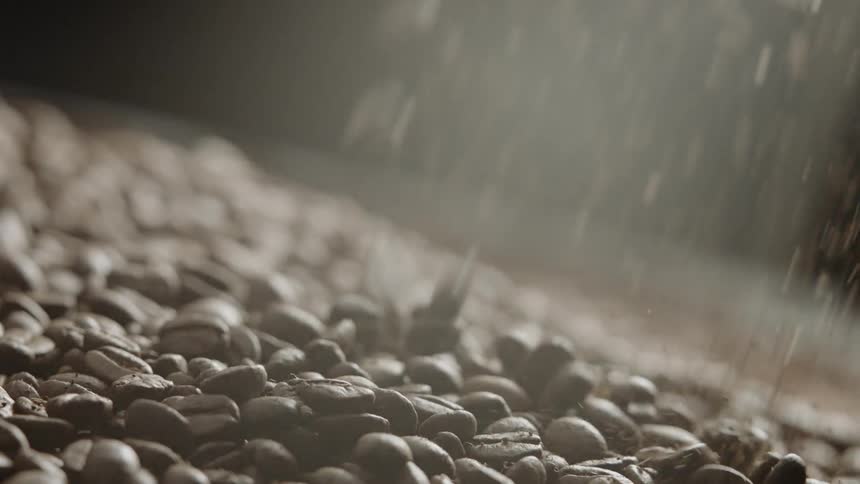 Coffee beans fall down into a large pile