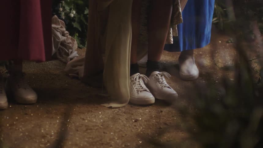 The people are standing together in the dirt
