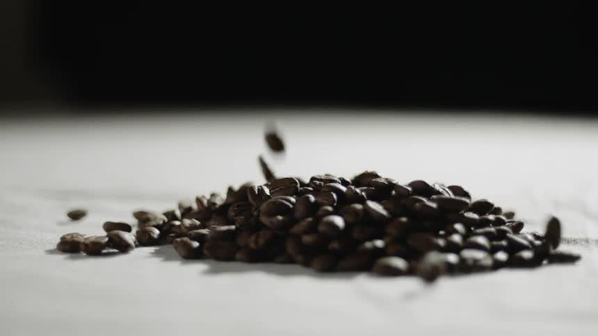 Coffee beans fall into a pile
