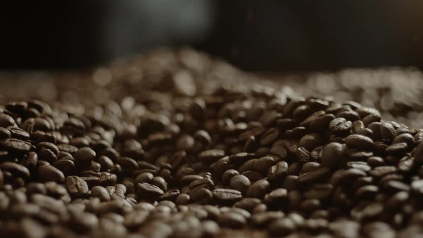 Coffee beans spill into a large pile