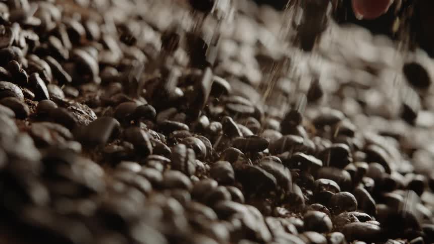 Coffee beans fall onto a pile