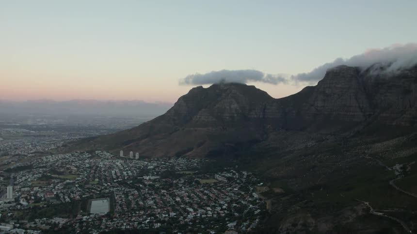 Buildings in a city sit near the mountains