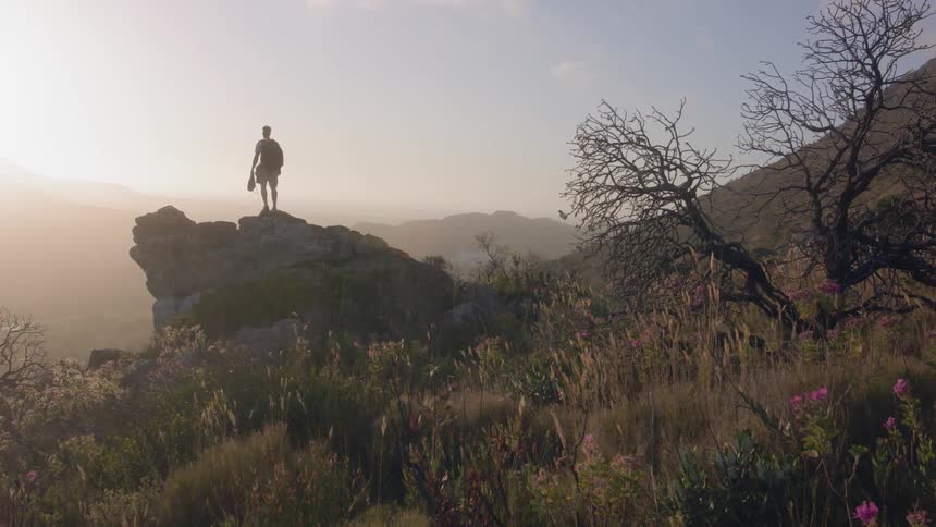 A man climbs on the rocks of the hill