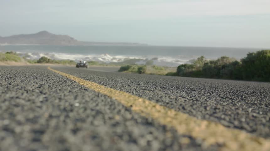 A yellow line is painted on the coastal road