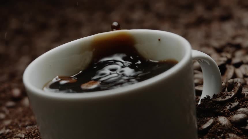 Coffee drips into a coffee cup