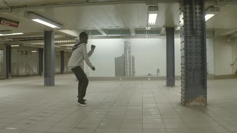 Boy dancing in a subway by himself