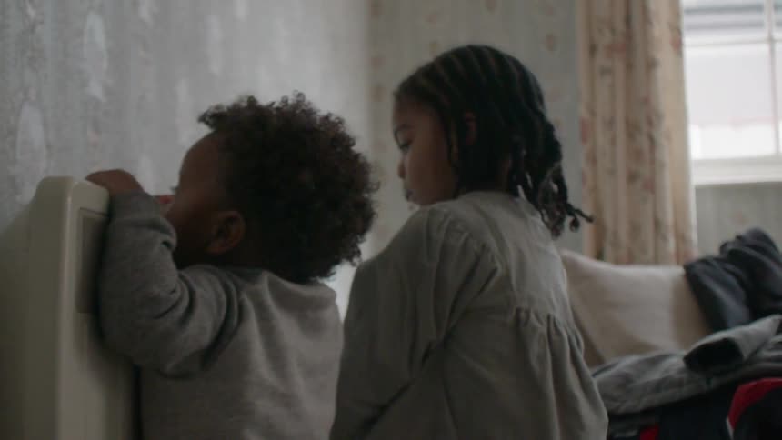 Two children play in a bedroom