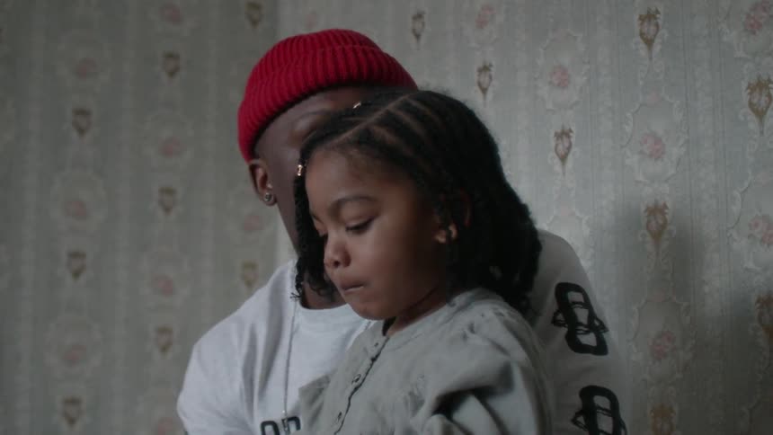 Man sits with a child on his lap