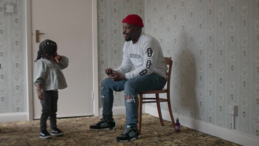 A man laughs at a young girl