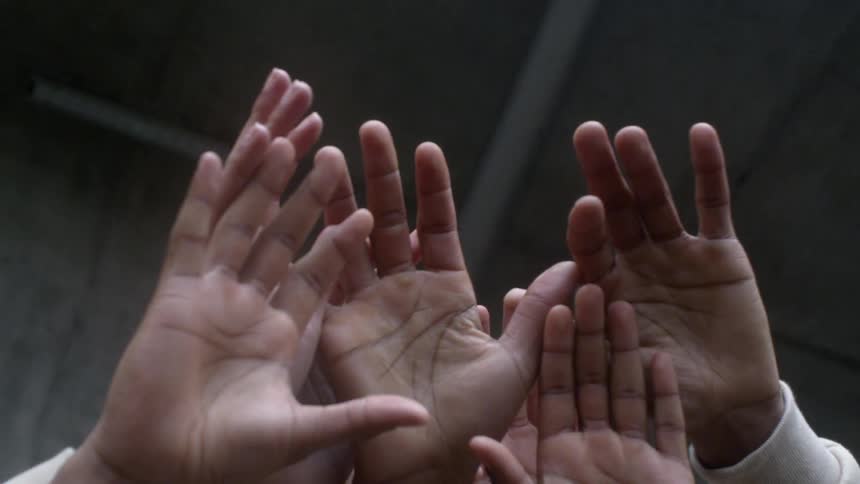 Several hands raised in the air