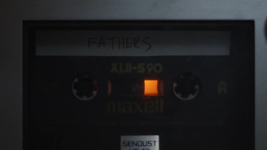 A cassette tape plays
