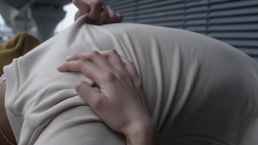 A person leaning down hugging others