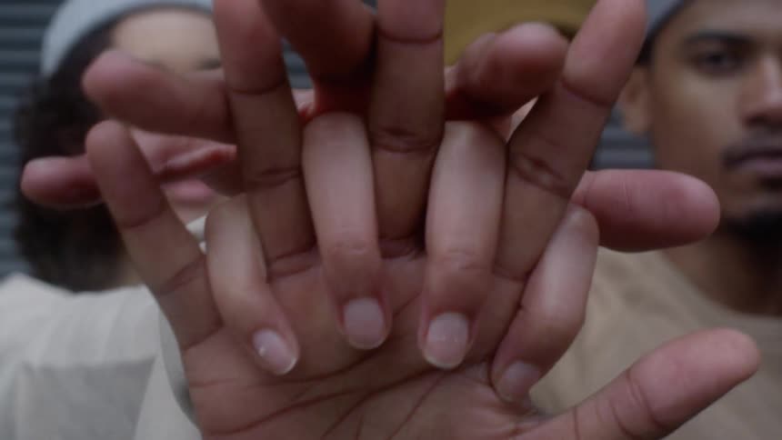 People all clasp their hands together