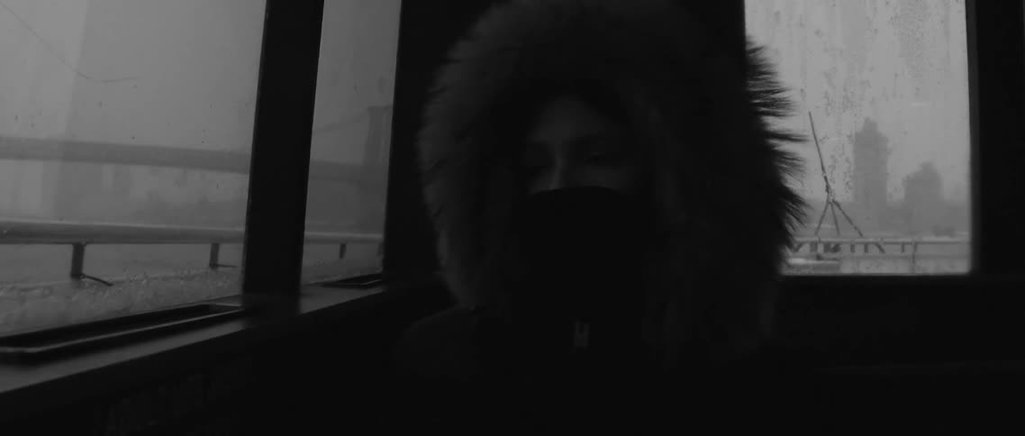 Person sitting inside a boat on a rainy day