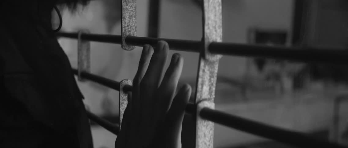 Persons hand on a shop gate