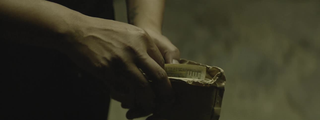 A person handing another person an envelope full of money