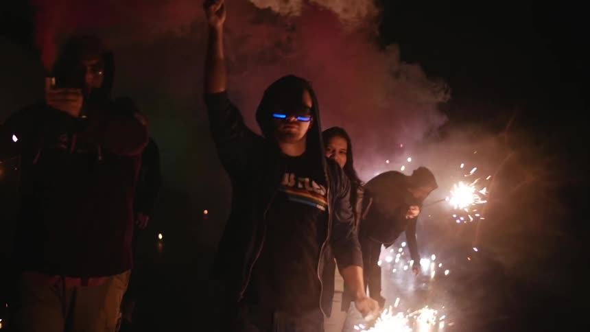 A group of people holding sparklers