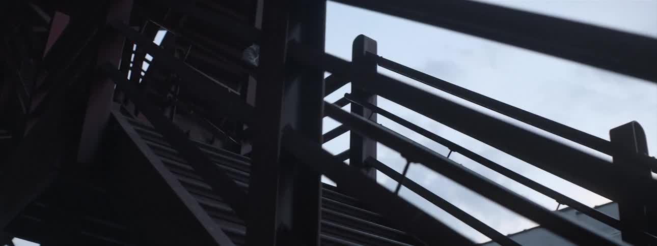 Young man descends an outdoor staircase