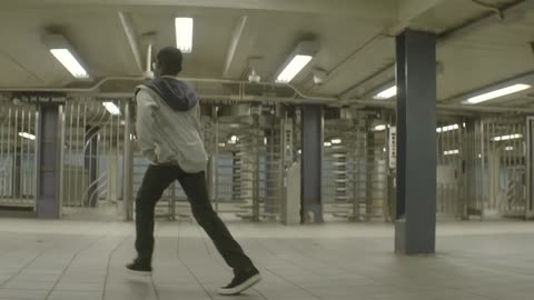 A boy dancing in an underground structure