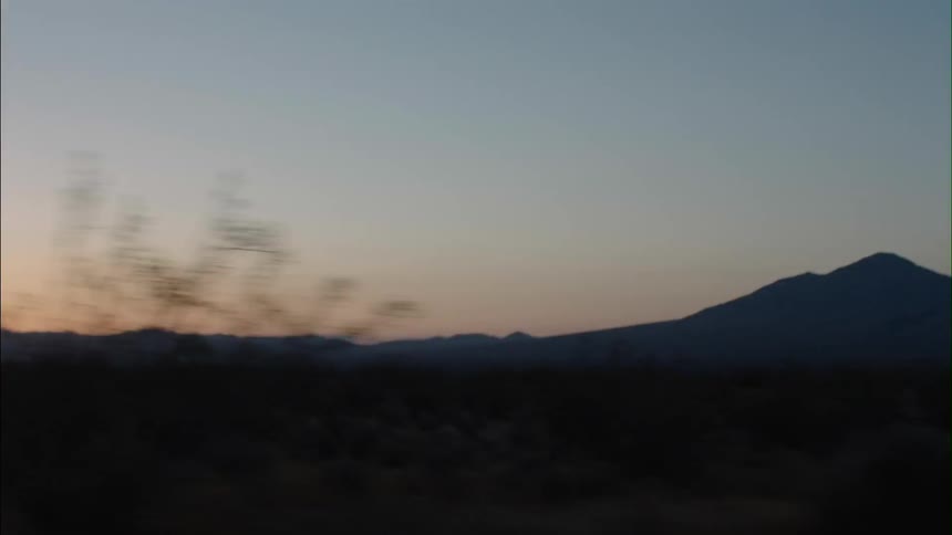 View of a long field with mountains in the distance