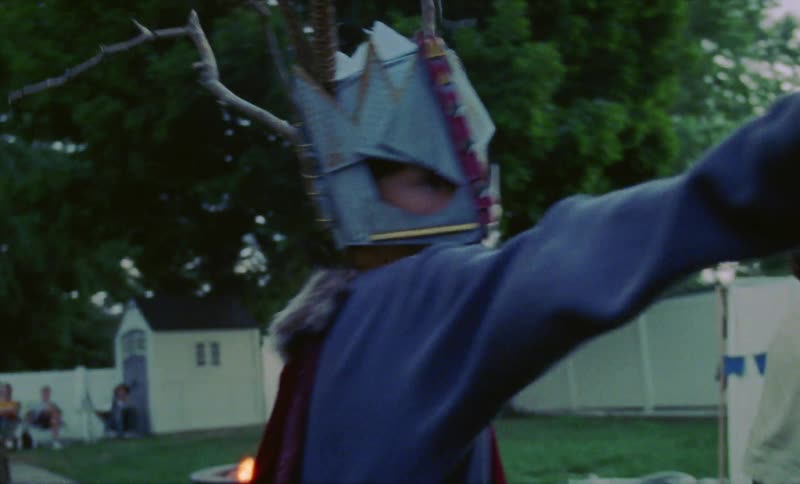 Children play gladiators in the backyard