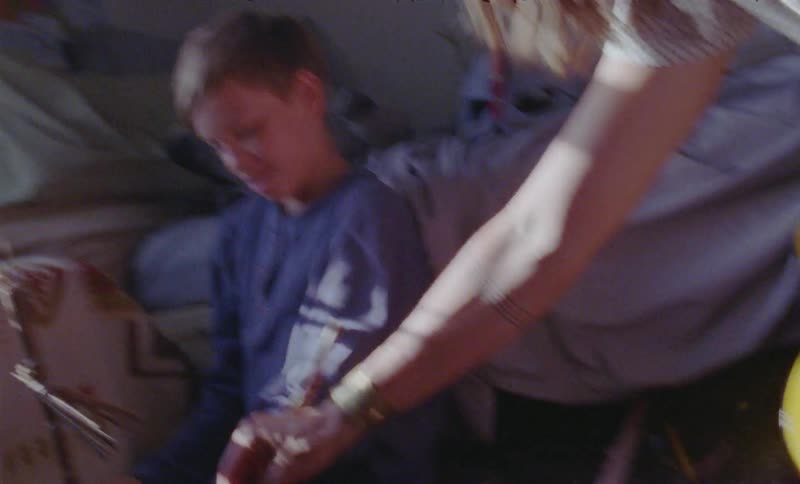 A child and parent play in the bedroom together
