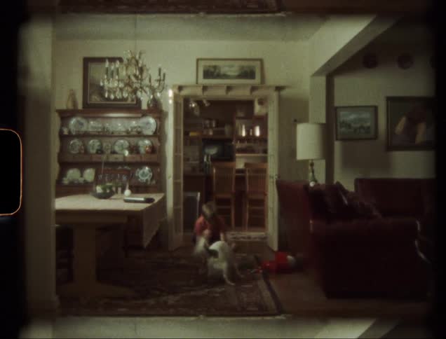 A child runs with the dog down the hall