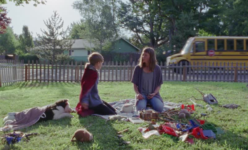 Child plays with his mother in the yard