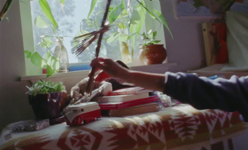 Boy is playing with stick figurine toy in bedroom