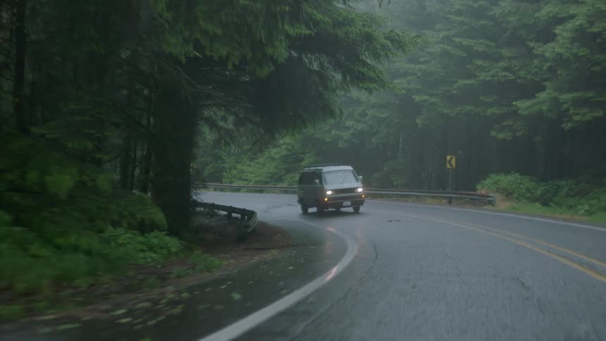 Van is driven on a rainy forest road