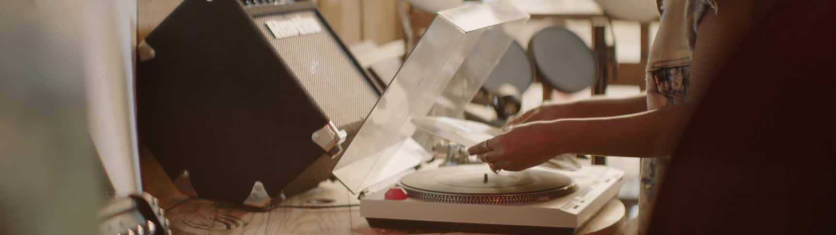 A woman puts a record in the player