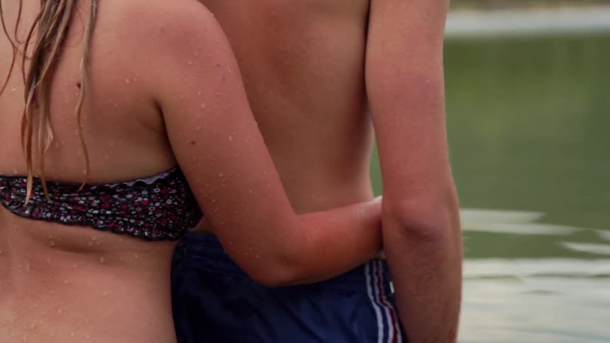 Man and woman swim in a lake